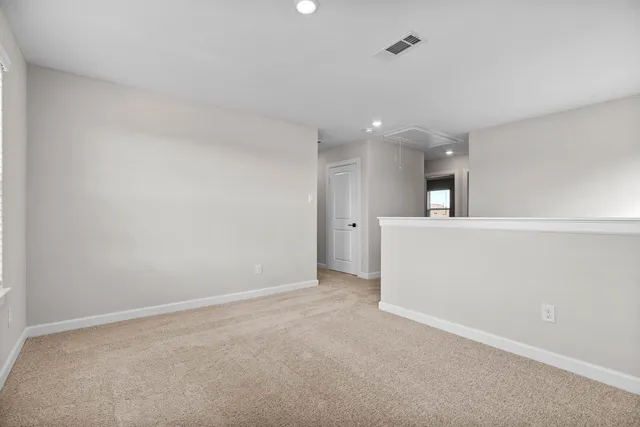 an empty room with a empty space and windows