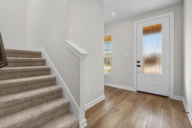 a view of an entryway with wooden floor