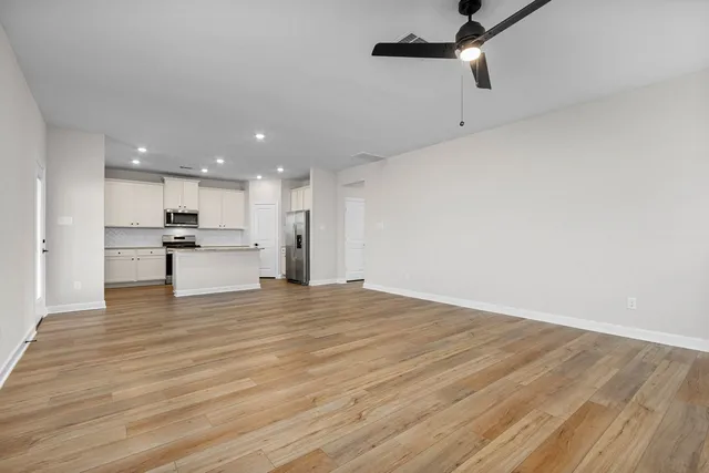 a view of a kitchen with a sink and wooden floor