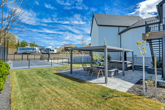 1720 Hillcrest Circle Mapleton, UT 84664 - Photo 102 of 116 Fenced backyard featuring a hot tub, a patio, basketball hoop, and a residential view