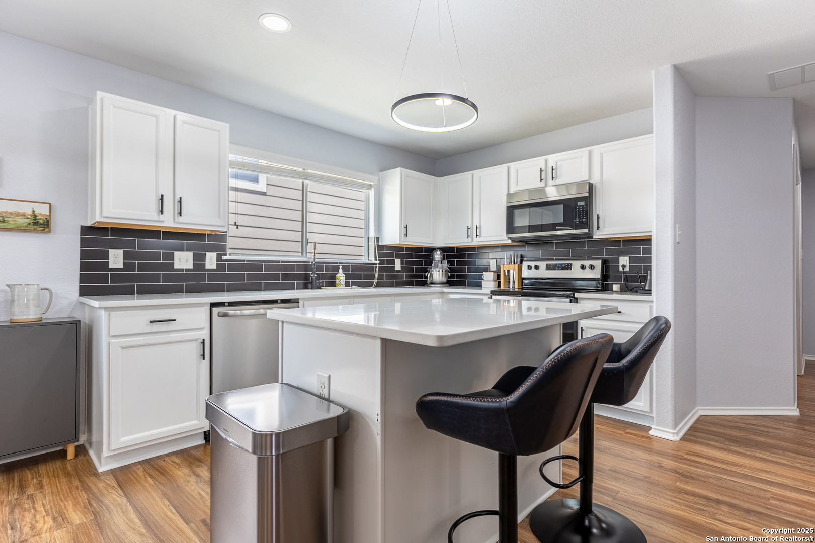 a kitchen with kitchen island granite countertop a sink and counter space