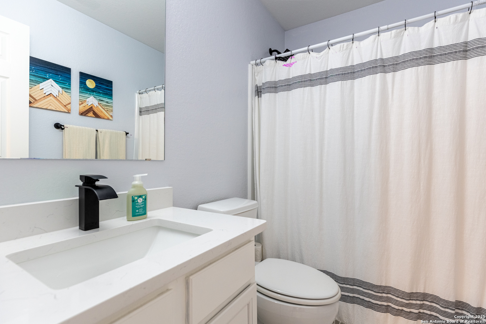 9518 Lookover Bay Converse, TX 78109 - Photo 24 of 30 a bathroom with a sink a toilet and shower curtain