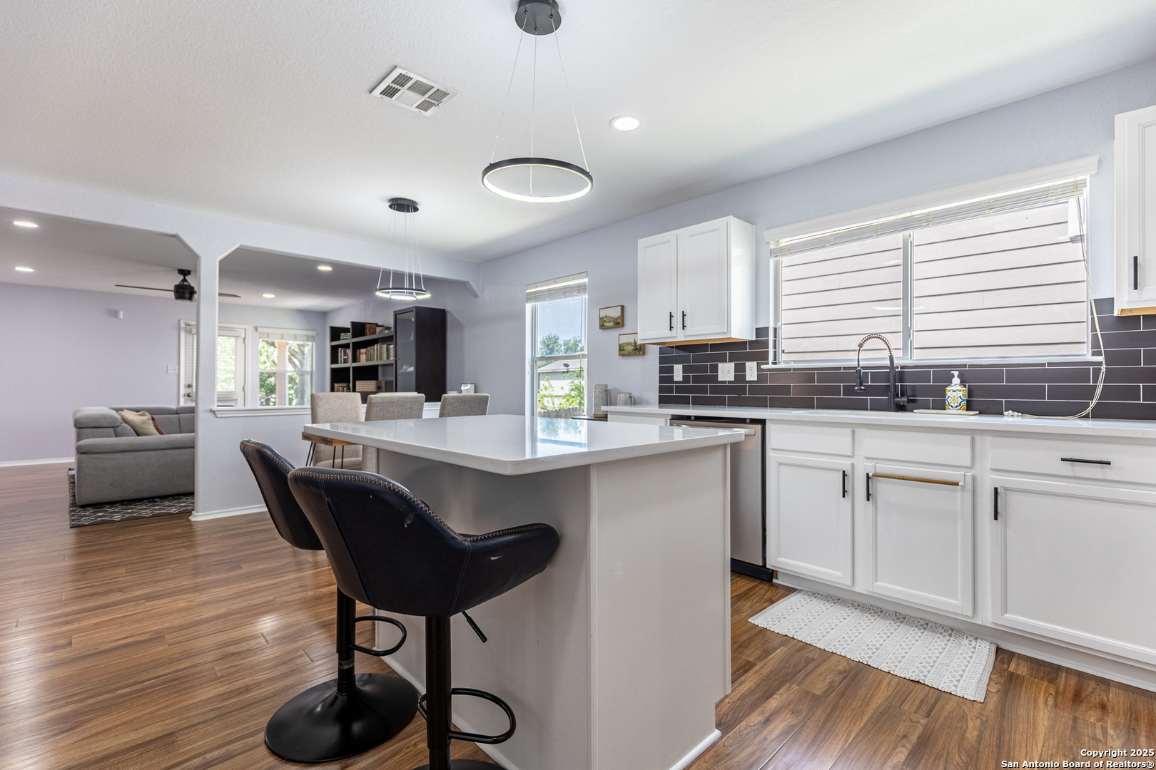 9518 Lookover Bay Converse, TX 78109 - Photo 6 of 30 a kitchen with stainless steel appliances kitchen island granite countertop a sink and cabinets