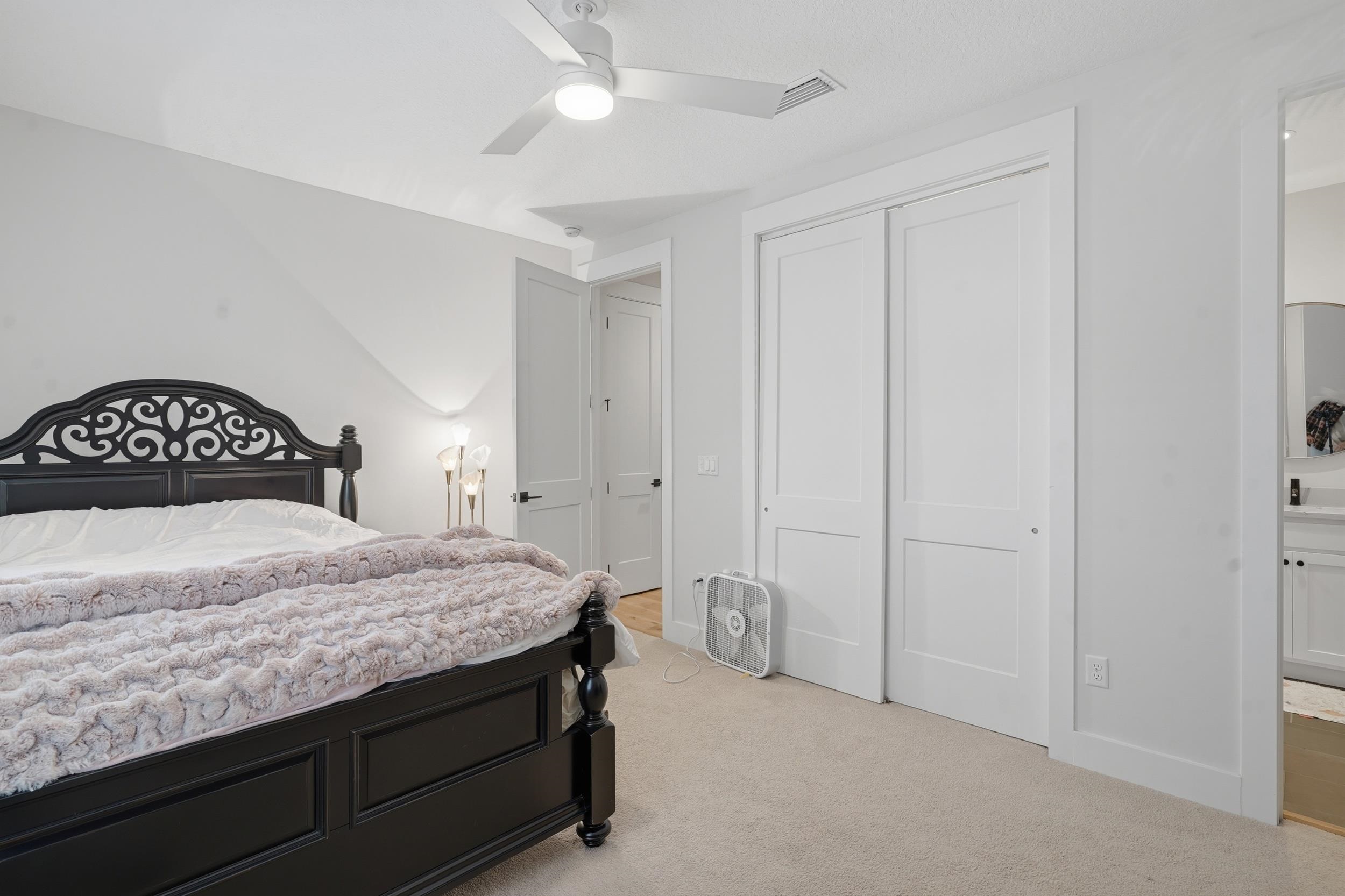 240 Ridgeway Road St. Augustine, FL 32080 - Photo 11 of 38 Bedroom featuring light carpet, ceiling fan, a closet, and ensuite bath
