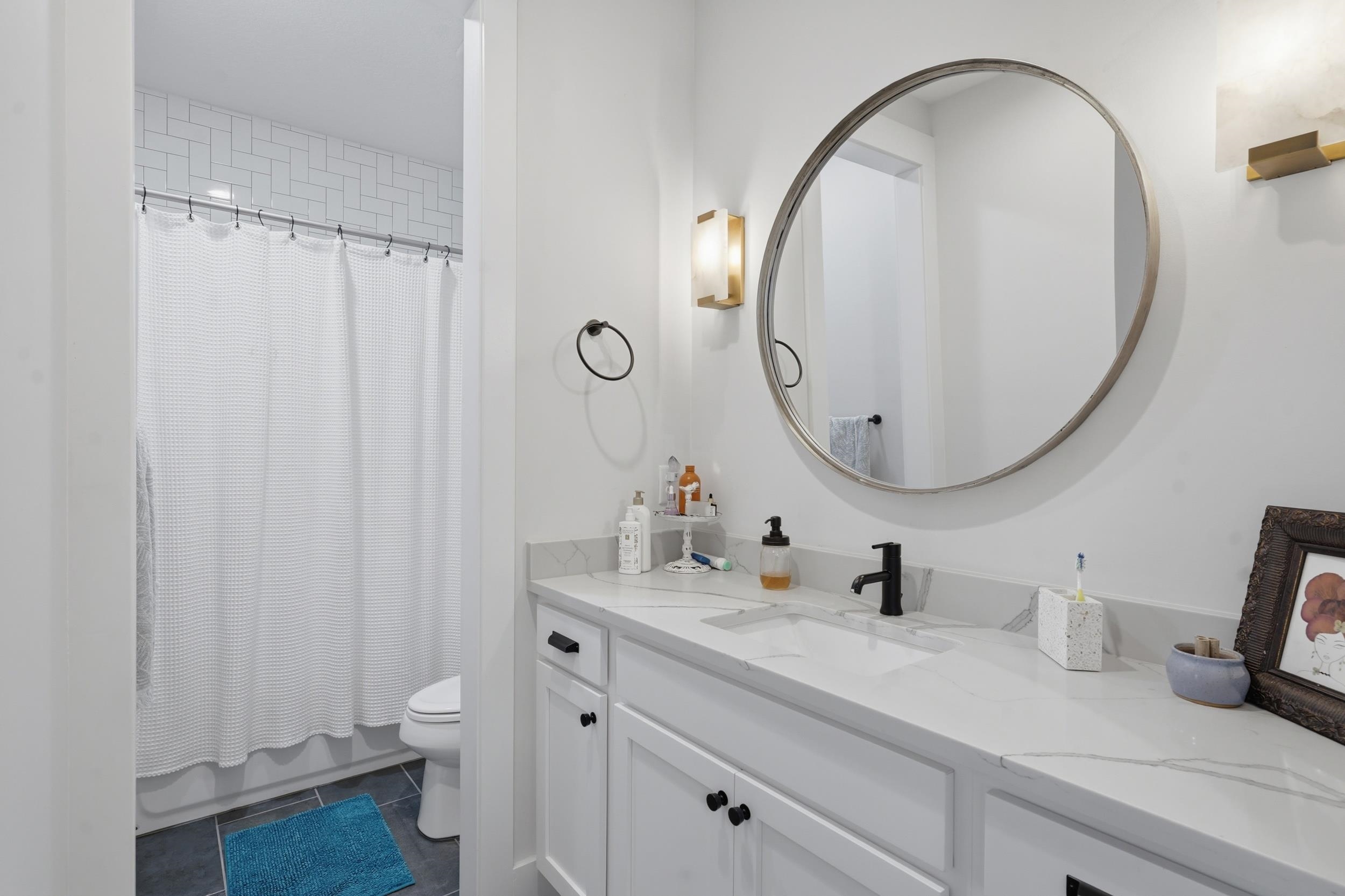 240 Ridgeway Road St. Augustine, FL 32080 - Photo 12 of 38 Full bath featuring vanity, dark tile patterned flooring, and shower / bath combination with curtain