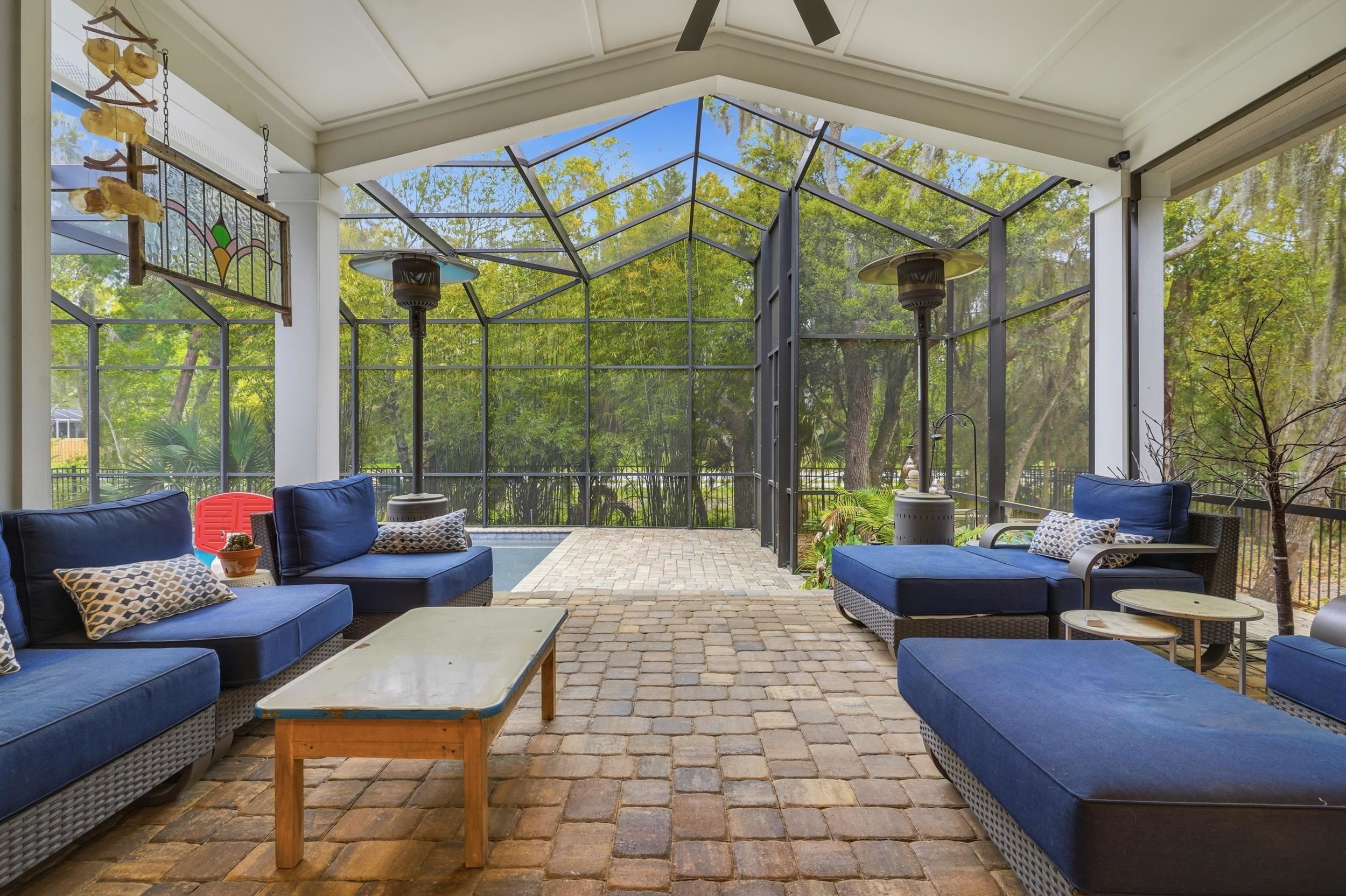 240 Ridgeway Road St. Augustine, FL 32080 - Photo 2 of 38 View of patio / terrace featuring outdoor seating, a lanai, and a sunroom