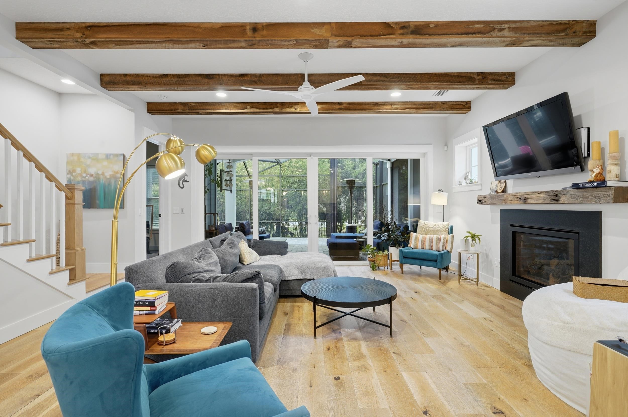 240 Ridgeway Road St. Augustine, FL 32080 - Photo 23 of 38 Living area with a ceiling fan, light wood-style floors, recessed lighting, beam ceiling, and a glass covered fireplace