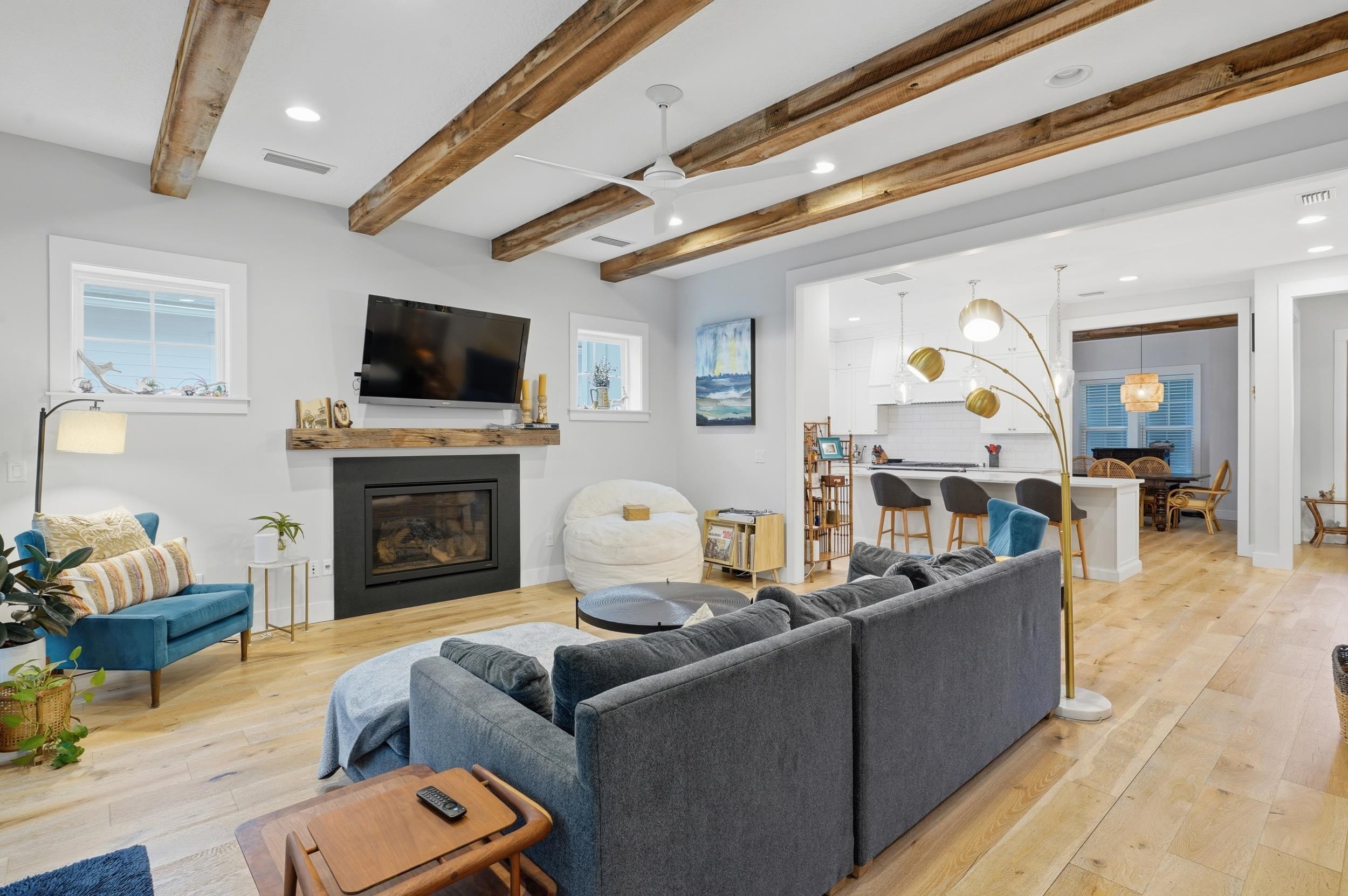 240 Ridgeway Road St. Augustine, FL 32080 - Photo 24 of 38 Living area featuring recessed lighting, light wood-style flooring, a ceiling fan, a glass covered fireplace, and beamed ceiling