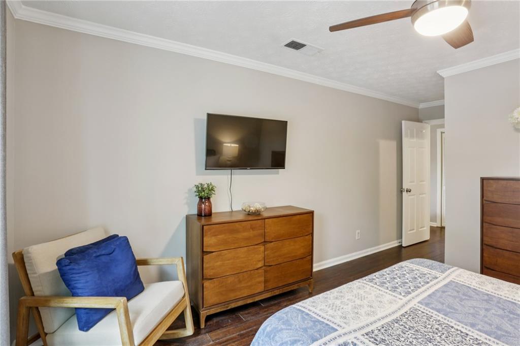 970 Sidney Marcus Boulevard Northeast, Unit 2115 Atlanta, GA 30324 - Photo 16 of 21 a bedroom with a bed and a flat screen tv