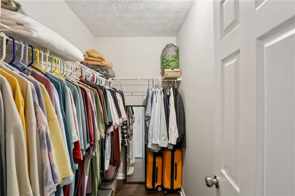 970 Sidney Marcus Boulevard Northeast, Unit 2115 Atlanta, GA 30324 - Photo 17 of 21 a view of walk in closet with clothes and shoes