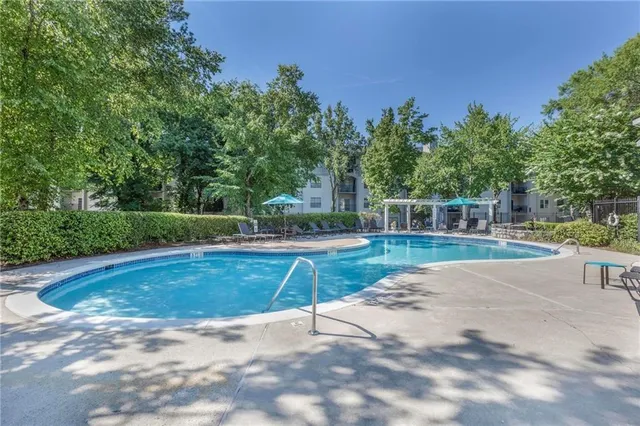 a view of a swimming pool with a yard