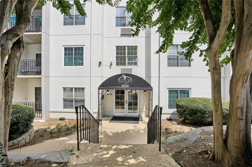 970 Sidney Marcus Boulevard Northeast, Unit 2115 Atlanta, GA 30324 - Photo 21 of 21 a front view of a house with a yard