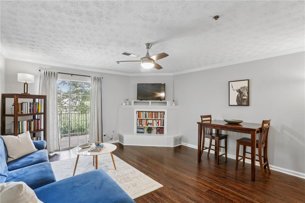 970 Sidney Marcus Boulevard Northeast, Unit 2115 Atlanta, GA 30324 - Photo 3 of 21 a living room with furniture wooden floor and a window