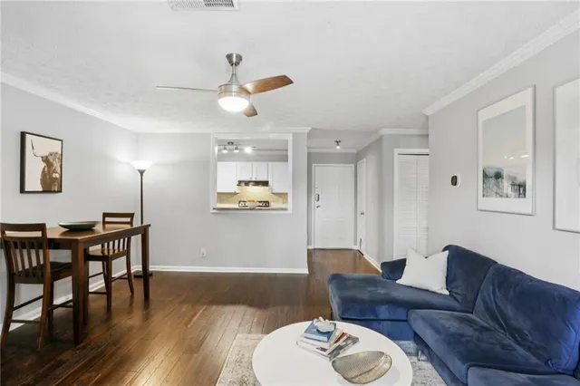 a living room with furniture and wooden floor