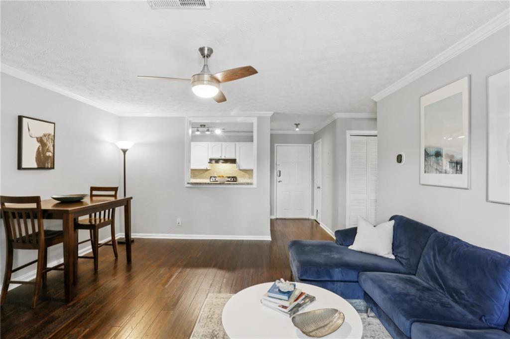 970 Sidney Marcus Boulevard Northeast, Unit 2115 Atlanta, GA 30324 - Photo 4 of 21 a living room with furniture and wooden floor