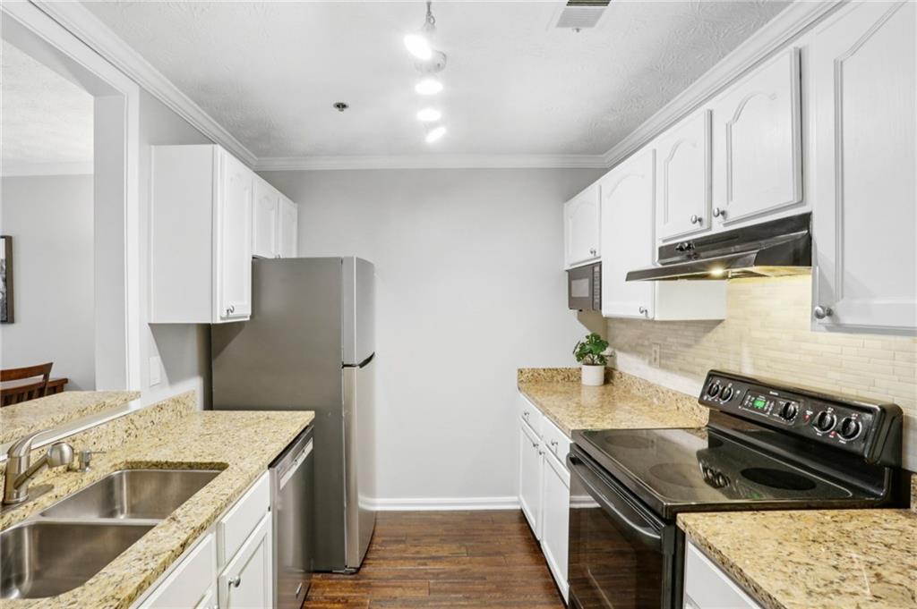 970 Sidney Marcus Boulevard Northeast, Unit 2115 Atlanta, GA 30324 - Photo 9 of 21 a kitchen with stainless steel appliances granite countertop a stove a refrigerator and a sink