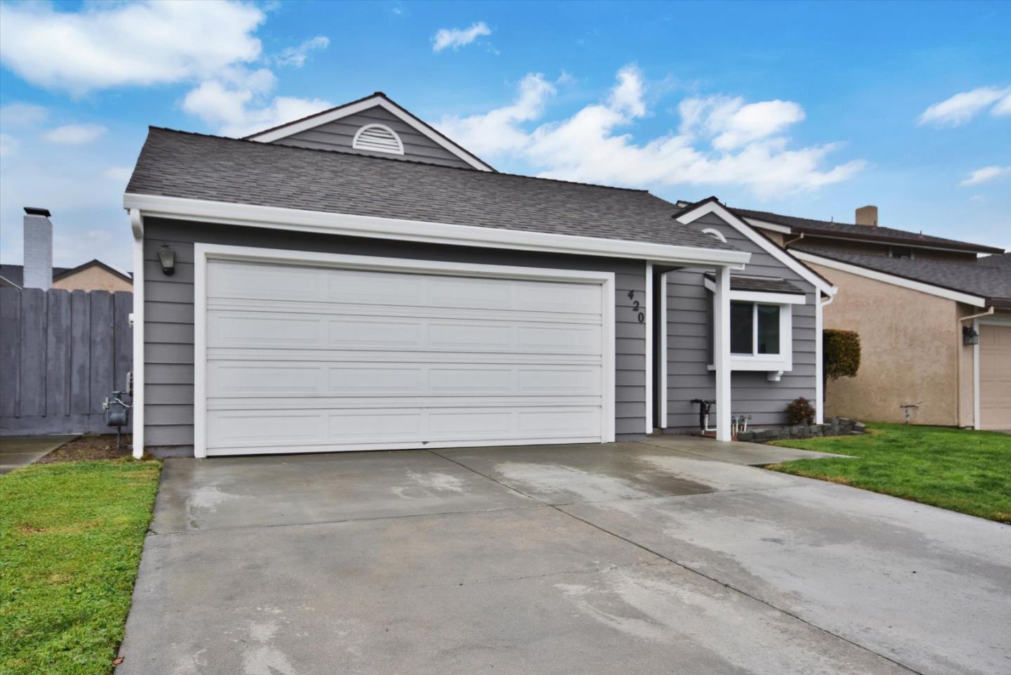 a view of a house with a yard and garage