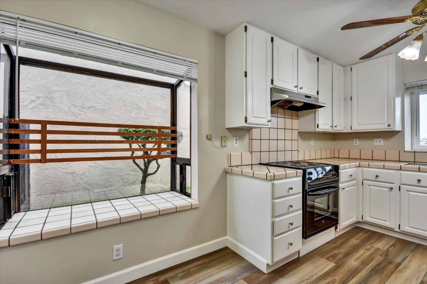 420 Brighton Street Salinas, CA 93907 - Photo 14 of 41 a kitchen with stainless steel appliances granite countertop a stove and a white cabinet with granite countertops