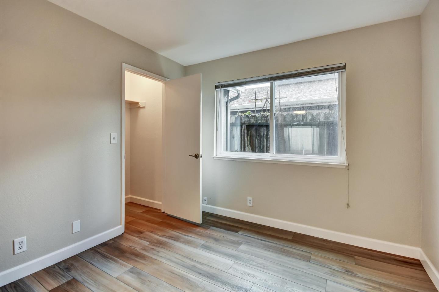 420 Brighton Street Salinas, CA 93907 - Photo 18 of 41 a view of an empty room with wooden floor and a window