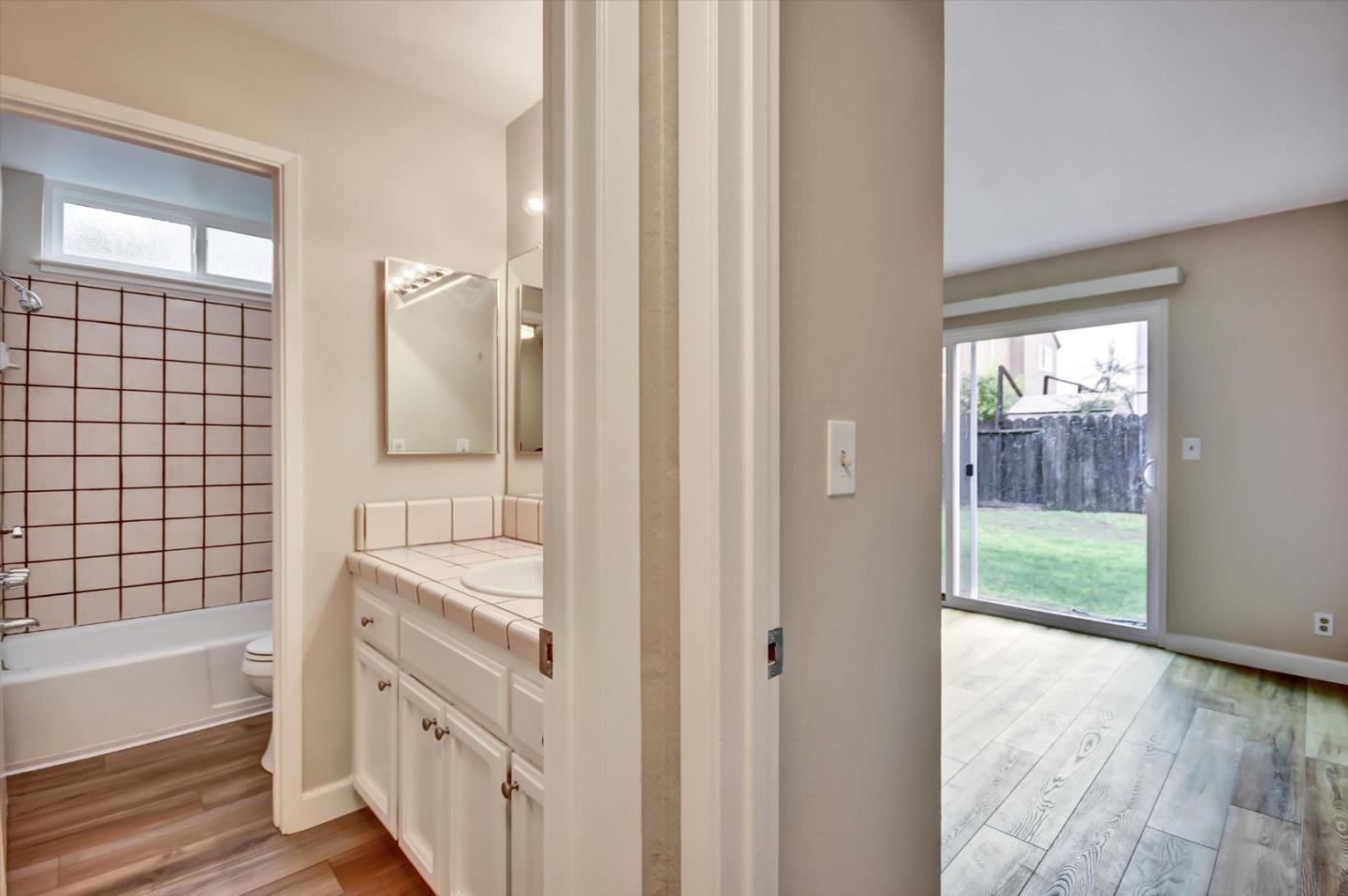 420 Brighton Street Salinas, CA 93907 - Photo 22 of 41 a bathroom with a granite countertop bathtub shower sink and mirror