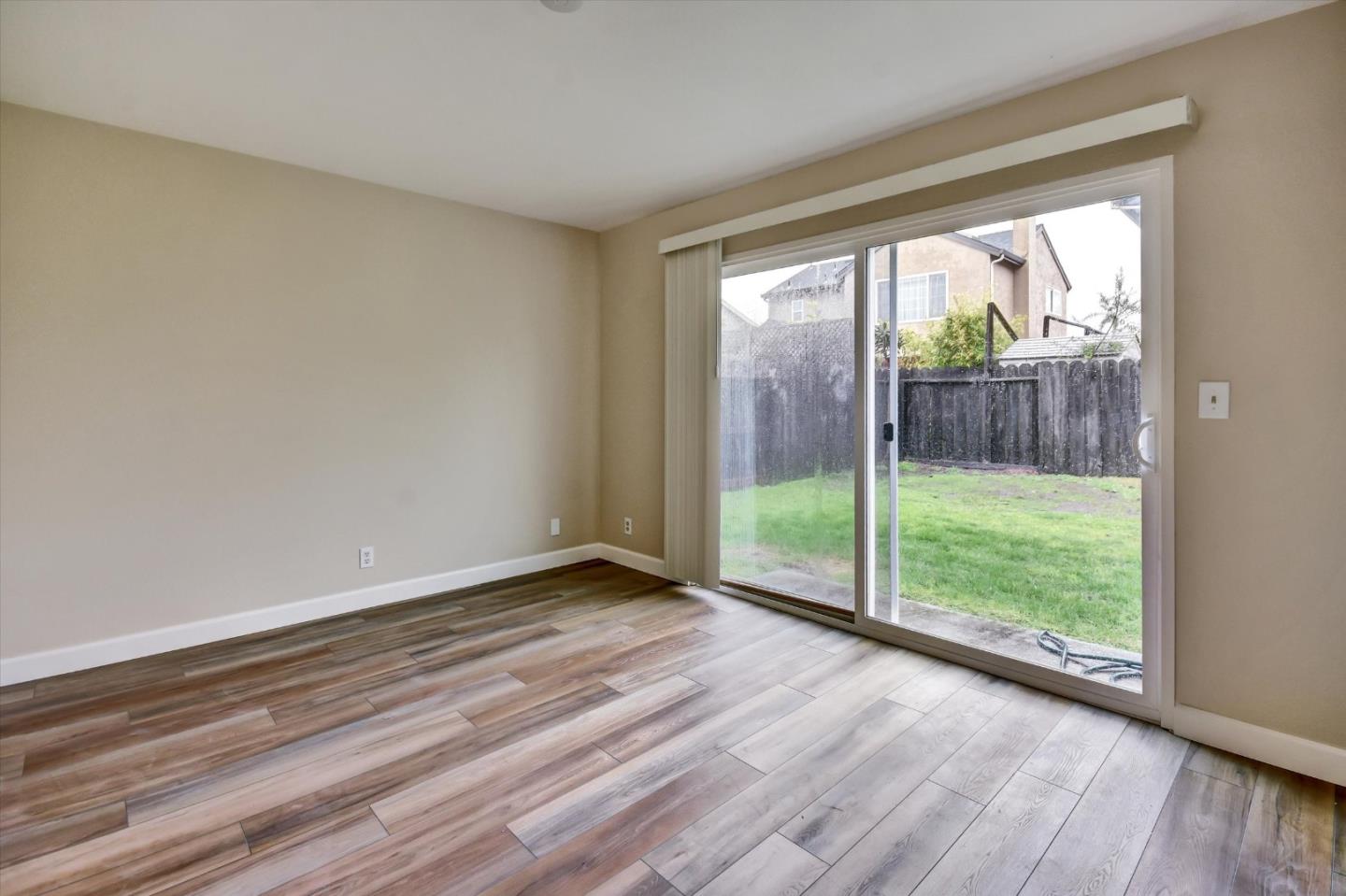 420 Brighton Street Salinas, CA 93907 - Photo 25 of 41 a view of an empty room with wooden floor and a floor to ceiling window