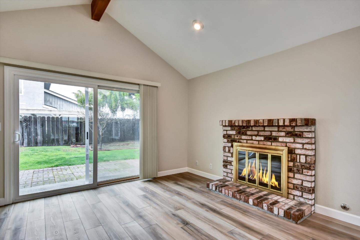 420 Brighton Street Salinas, CA 93907 - Photo 7 of 41 a view of a livingroom with wooden floor and a floor to ceiling window