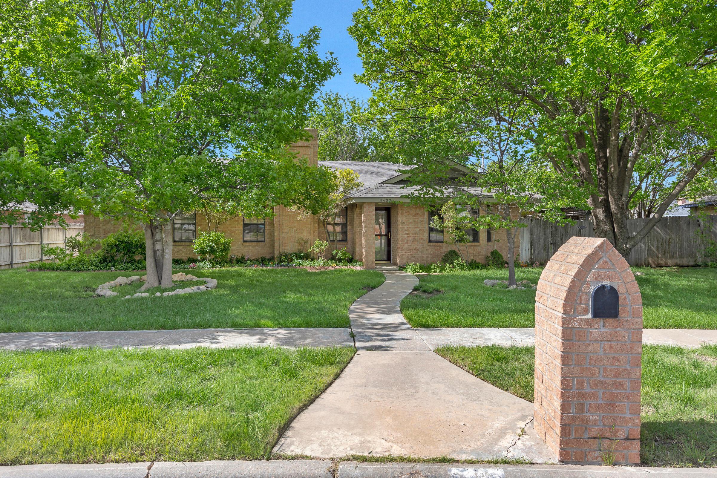 5403 Camp Lane Amarillo, TX 79110 - Photo 2 of 25 a front view of a house with a yard