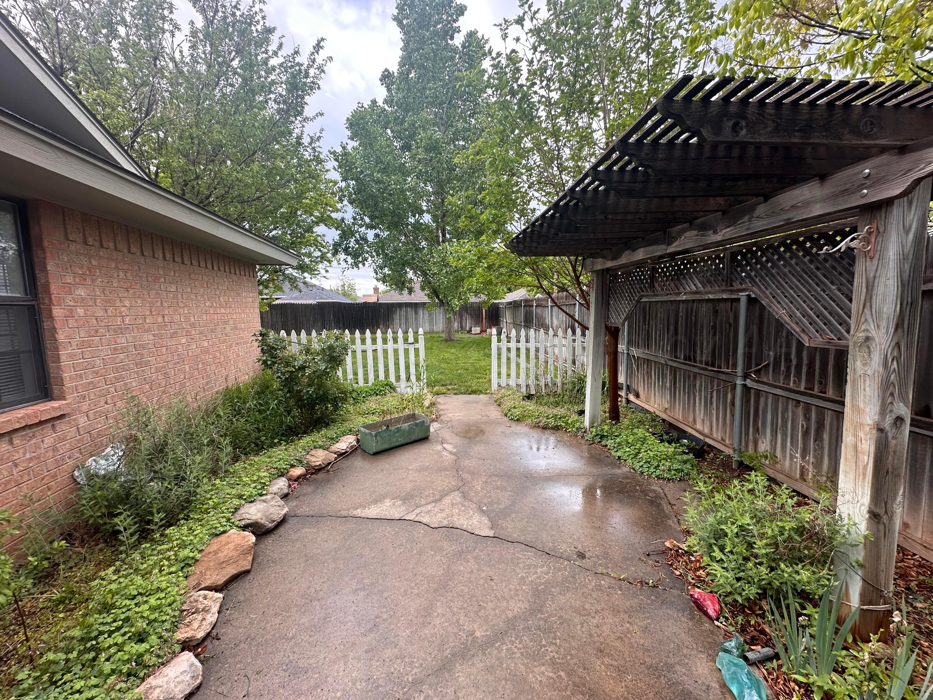 5403 Camp Lane Amarillo, TX 79110 - Photo 21 of 25 a view of a pathway of a house with a small yard