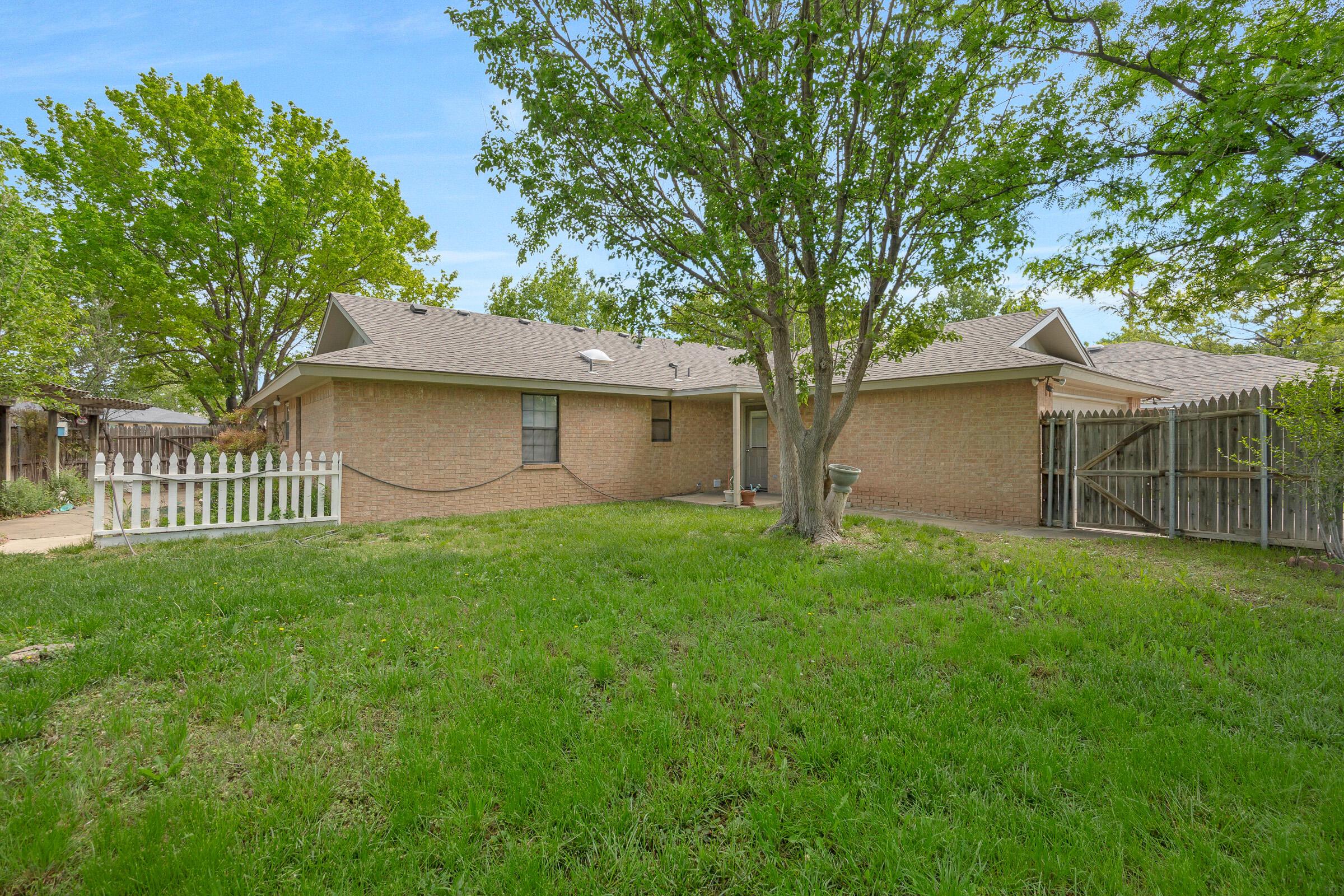 5403 Camp Lane Amarillo, TX 79110 - Photo 24 of 25 a front view of a house with a garden