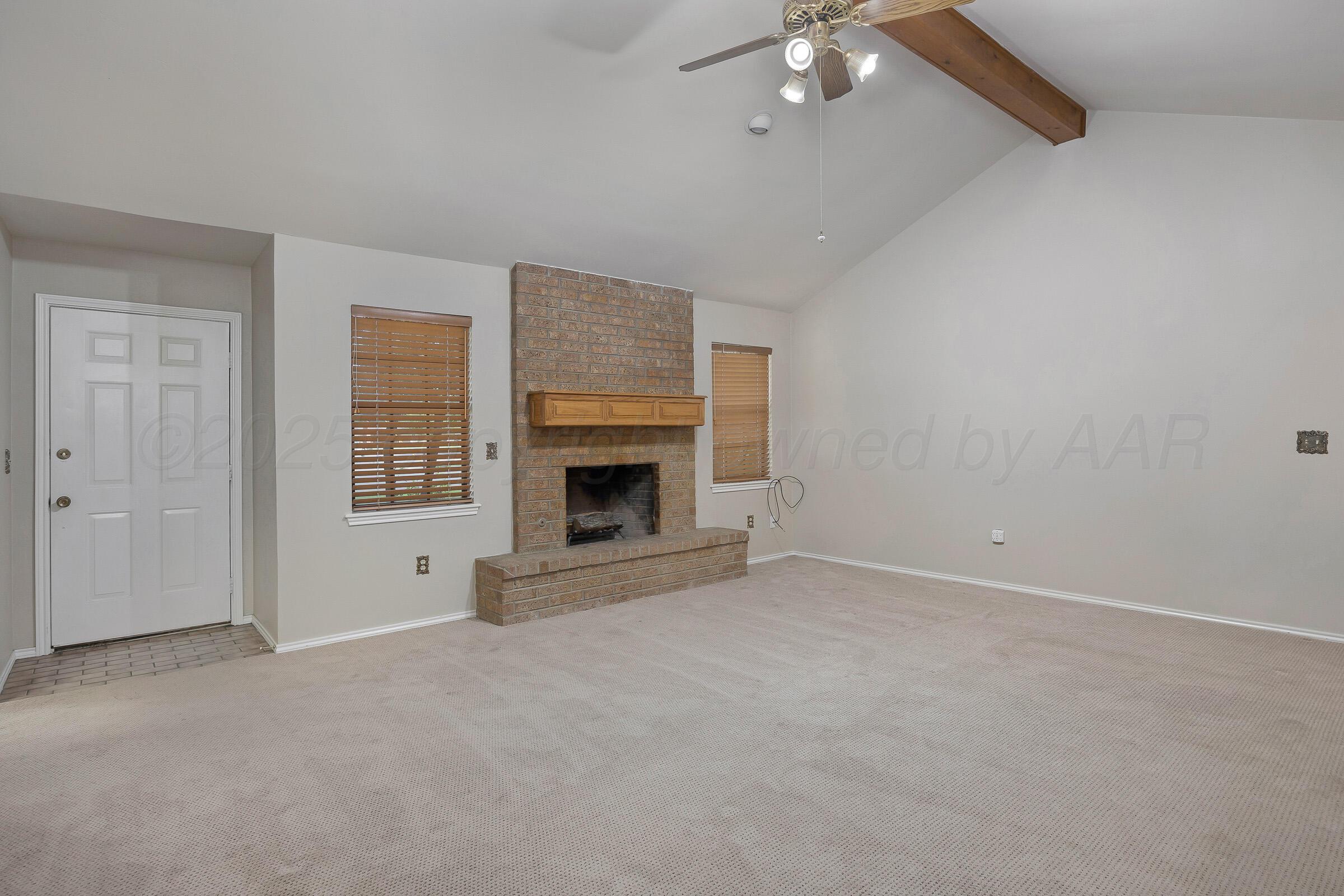 5403 Camp Lane Amarillo, TX 79110 - Photo 4 of 25 an empty room with fireplace and fan