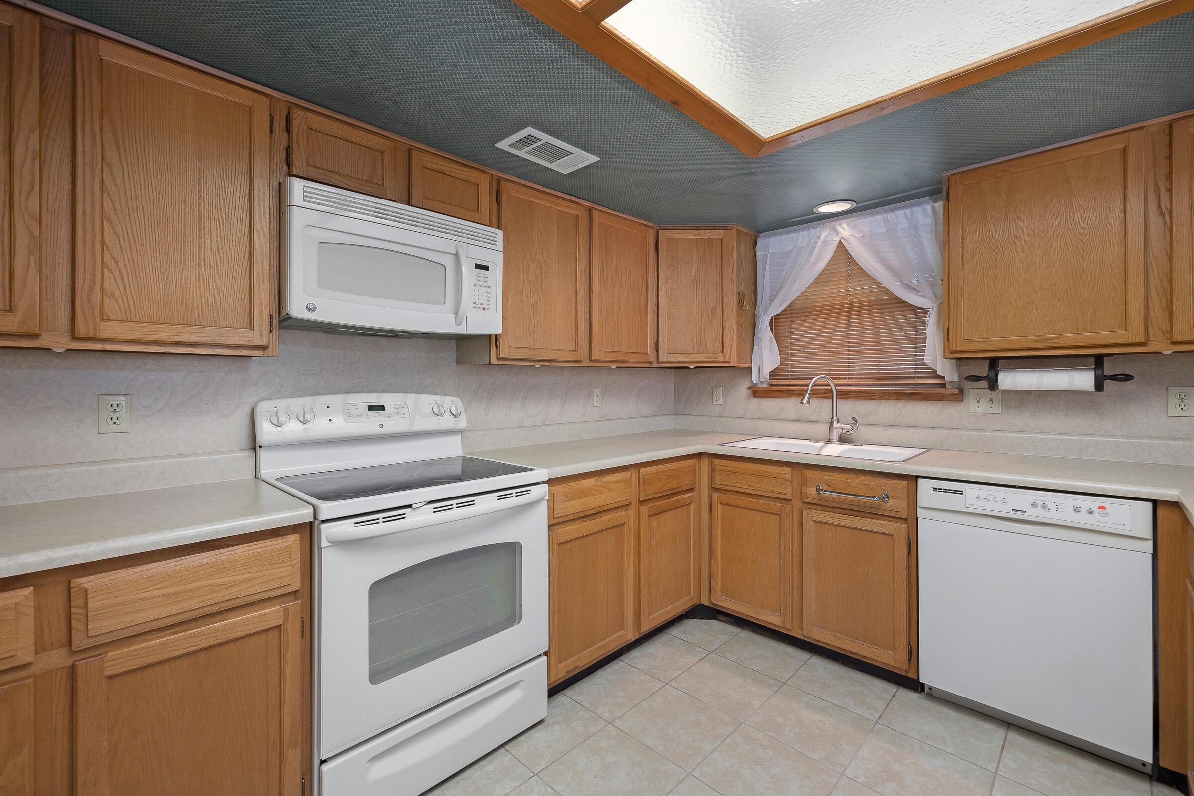5403 Camp Lane Amarillo, TX 79110 - Photo 7 of 25 a kitchen with granite countertop cabinets stainless steel appliances and a sink