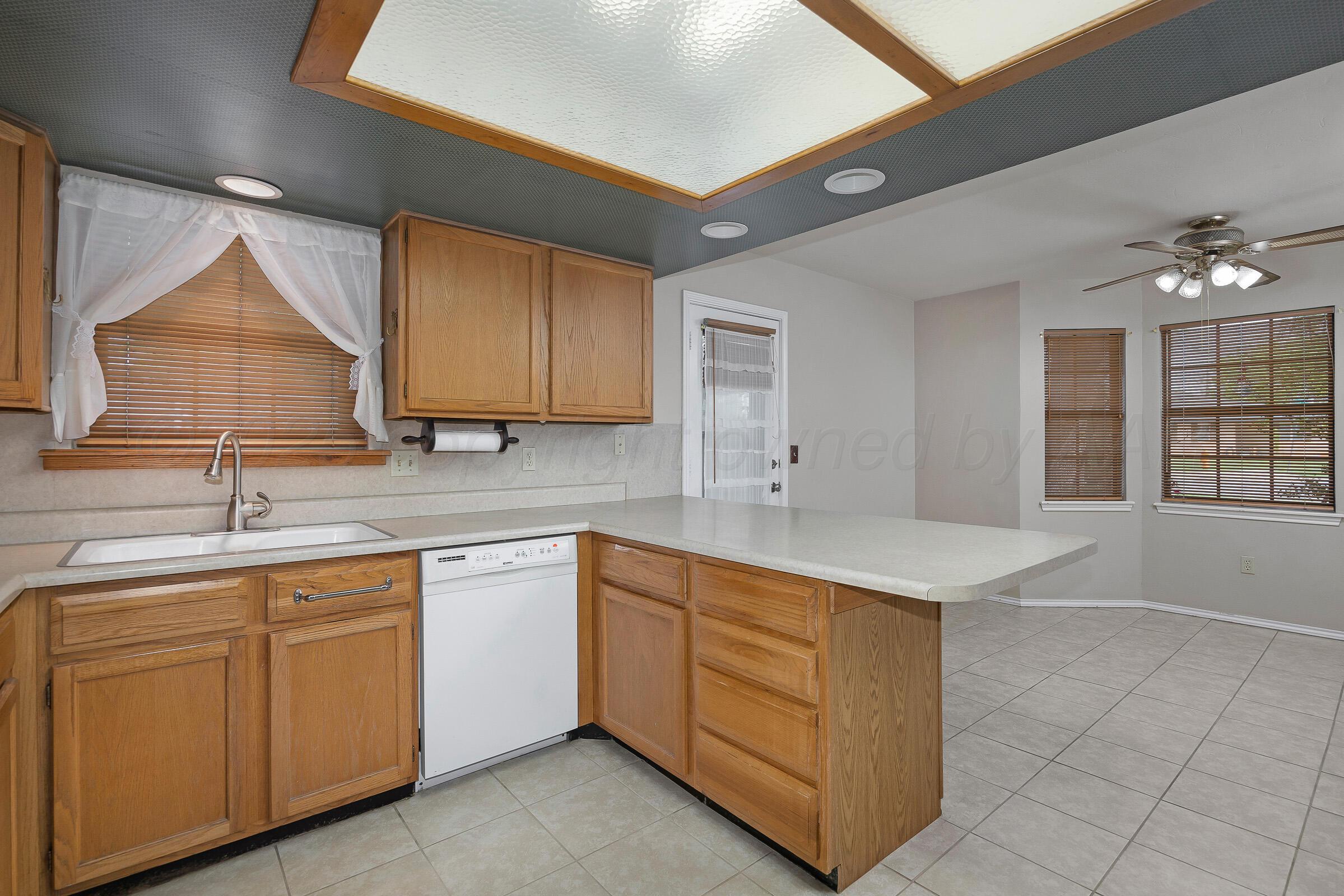 5403 Camp Lane Amarillo, TX 79110 - Photo 9 of 25 a kitchen with a sink and cabinets
