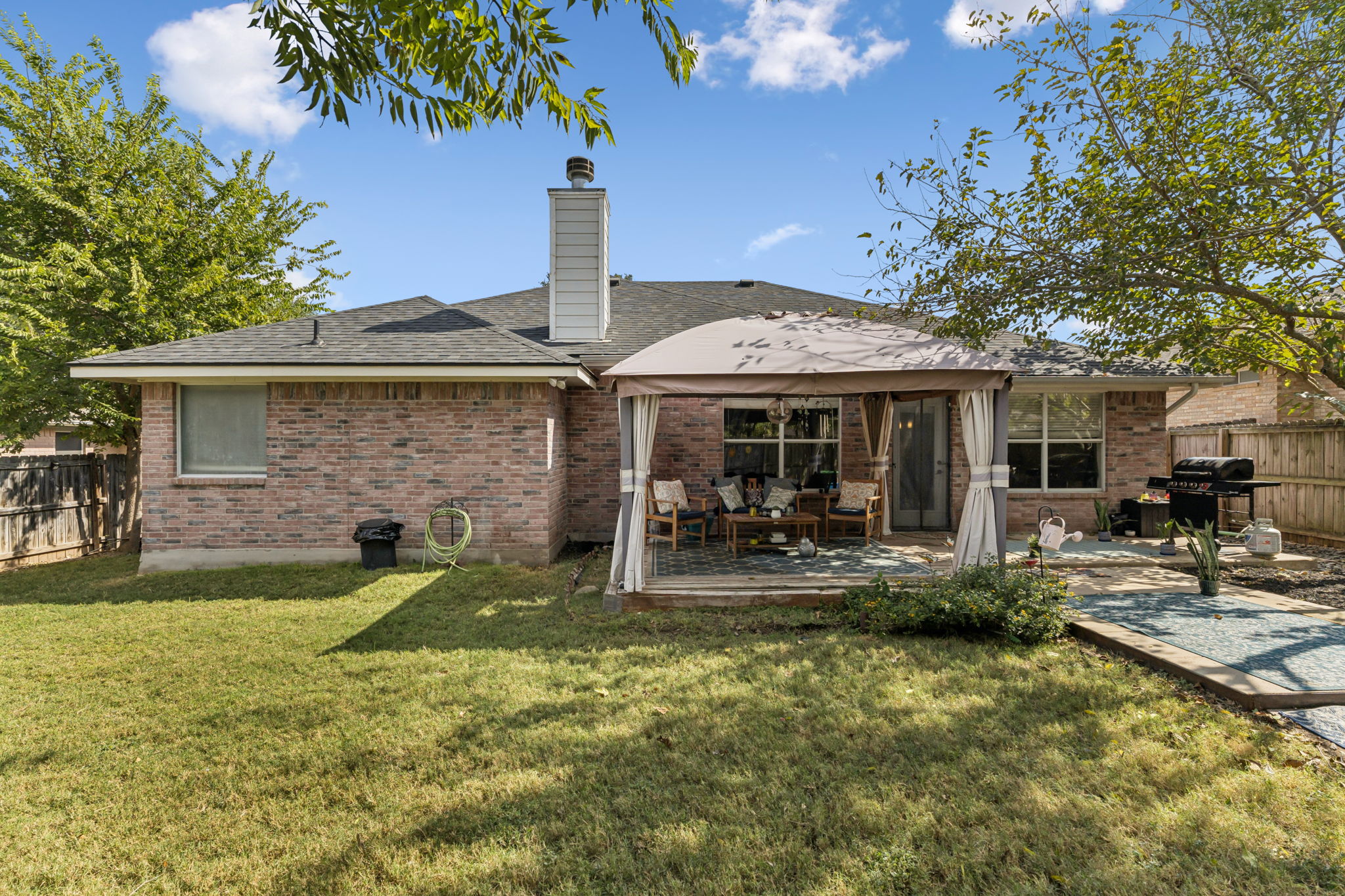 2412 Chestnut Path Round Rock, TX 78664 - Photo 20 of 26 A spacious backyard with a cozy covered patio offers an ideal setting for outdoor entertaining.