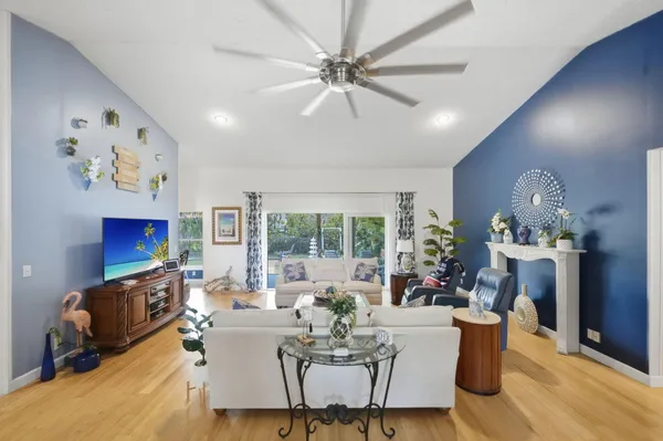 a living room with furniture a fireplace and a chandelier