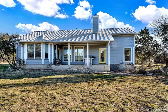 a view of a patio with table and chairs potted plants