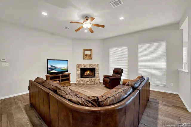 a living room with furniture fireplace and a flat screen tv