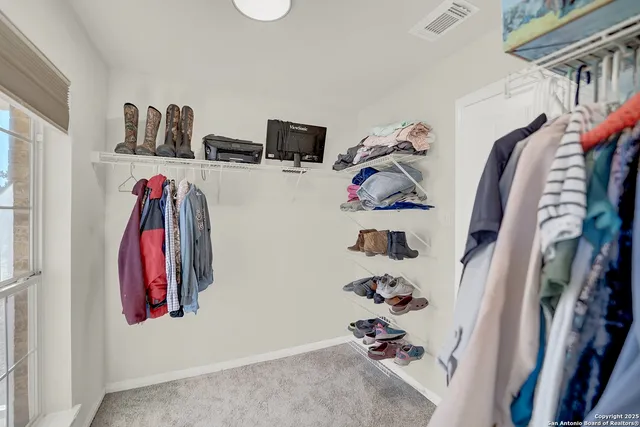 a spacious bathroom with a double vanity sink and a mirror