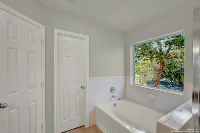 a bathroom with a glass shower door