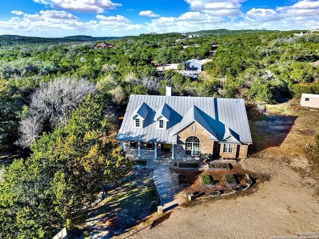 an aerial view of a house with a yard