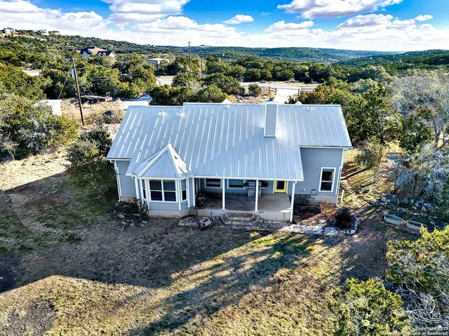 an aerial view of a house with a yard