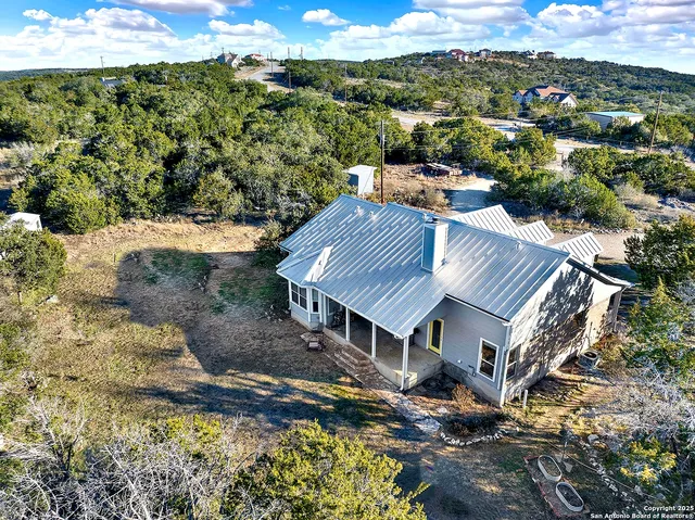 a view of a yard with wooden fence