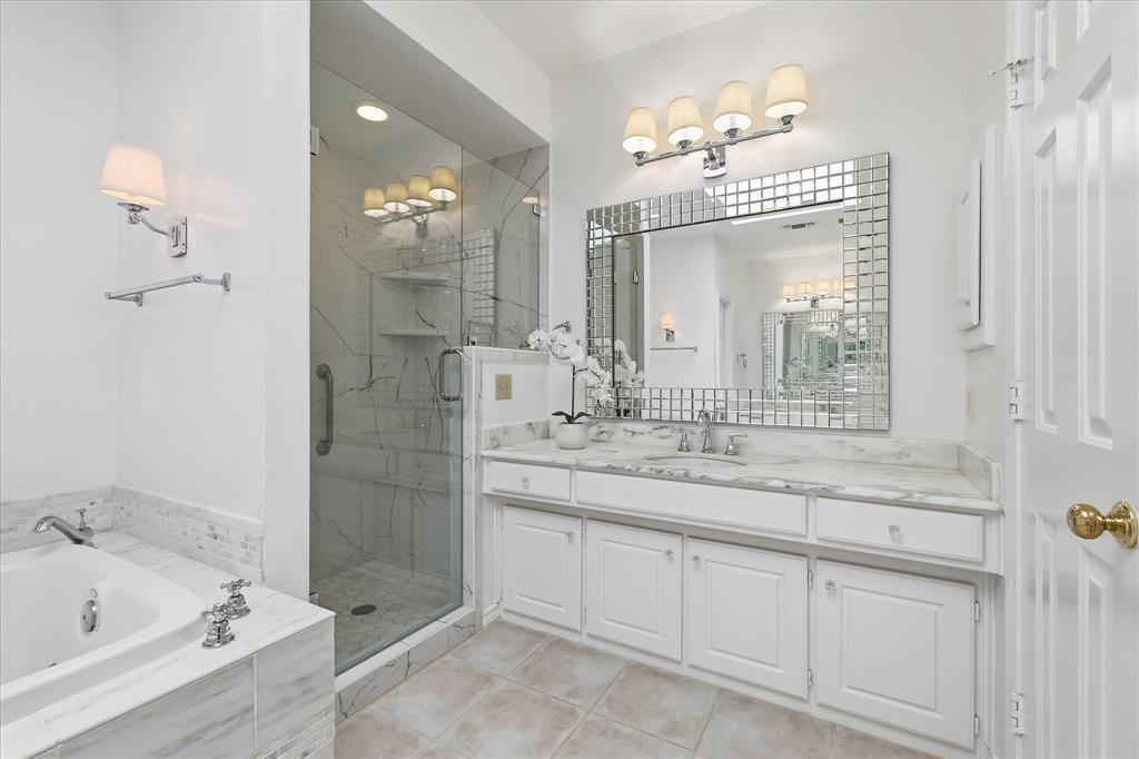 6955 Hawk Road Flower Mound, TX 75022 - Photo 24 of 40 Contemporary bathroom featuring a spacious glass-enclosed shower, a built-in bathtub, and an extended vanity with dual sinks
