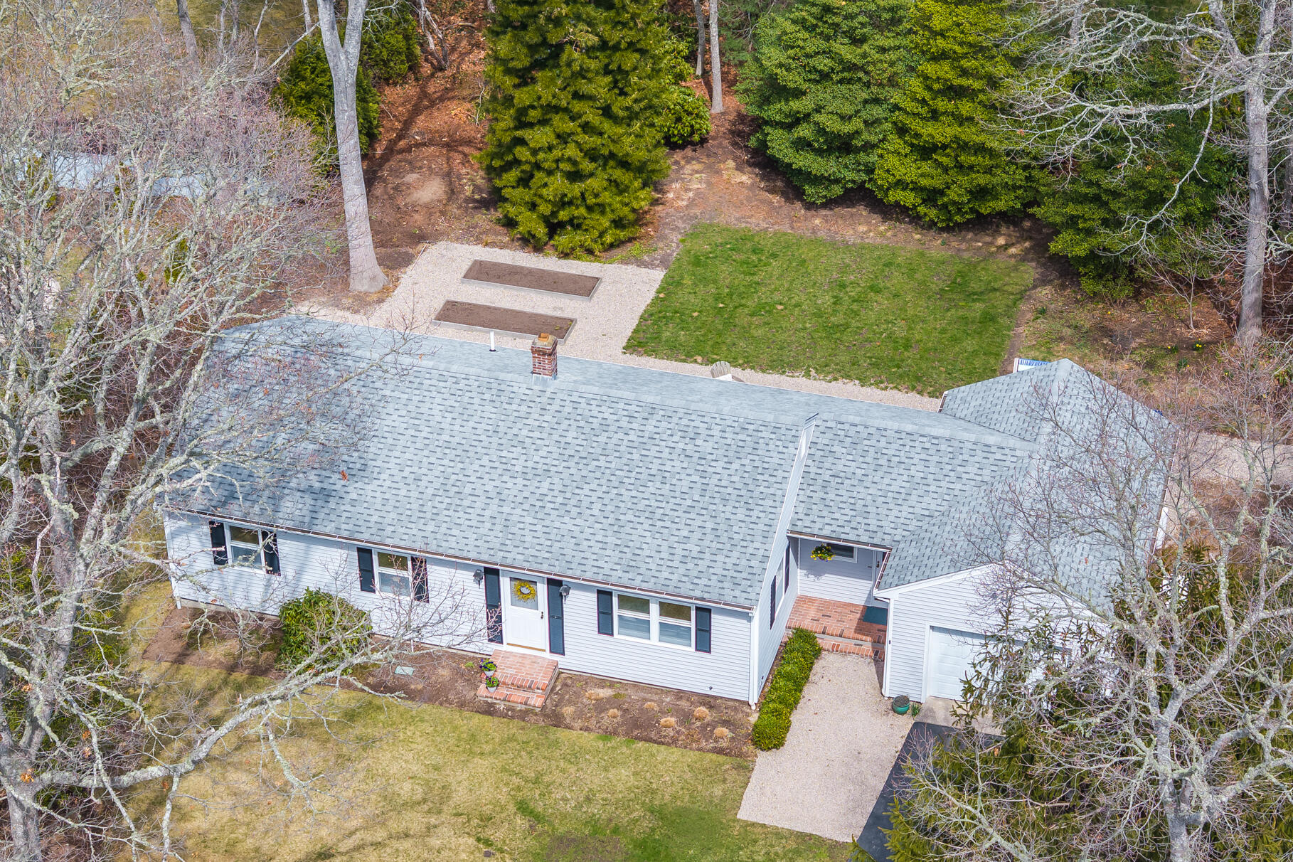 an aerial view of a house with pool and yard