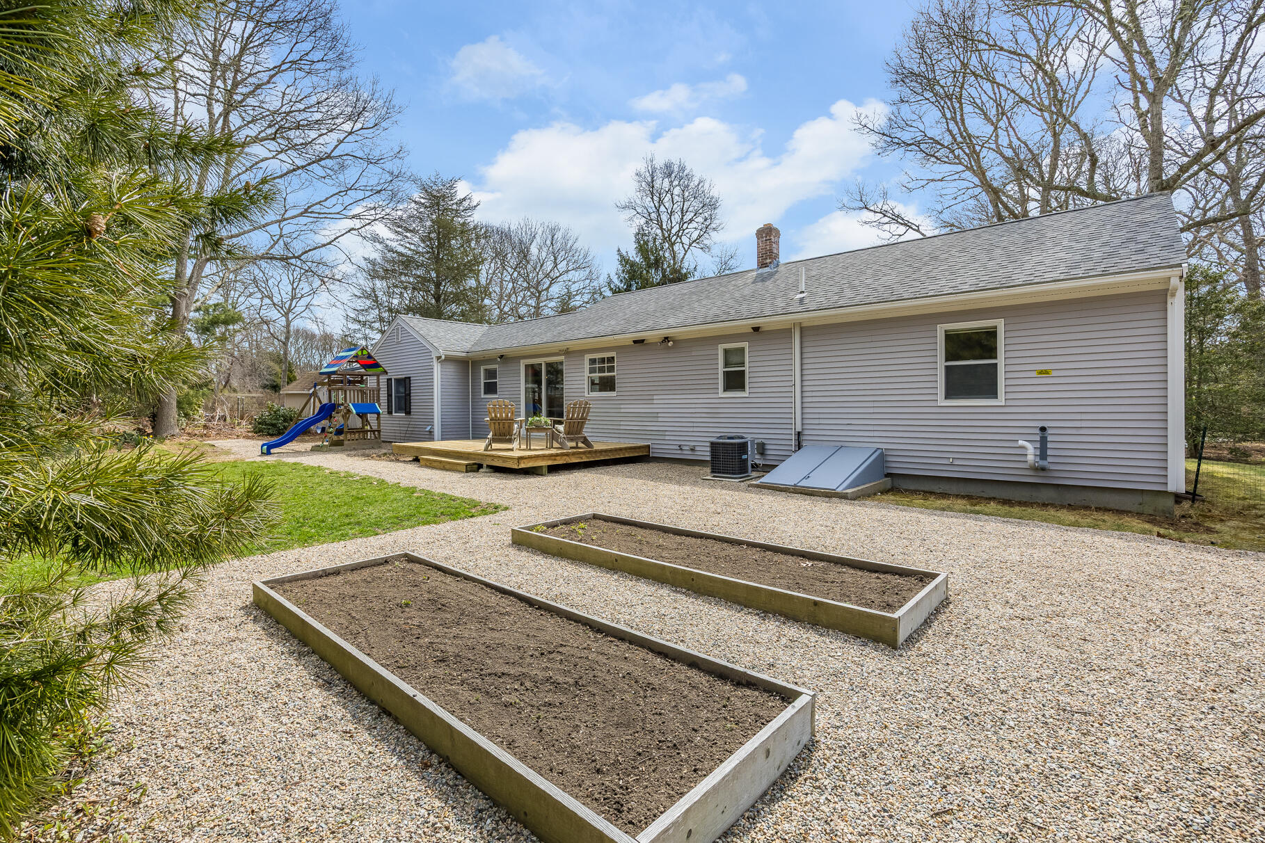 8 Rivers End Road Teaticket, MA 02536 - Photo 4 of 33 a view of a white house with a yard patio and wooden fence