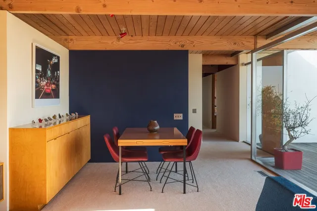 a kitchen with kitchen island granite countertop a refrigerator and a sink
