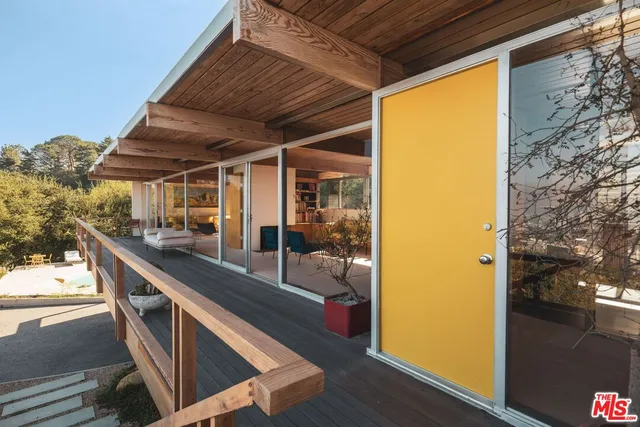 a building outdoor space with patio furniture and wooden floor