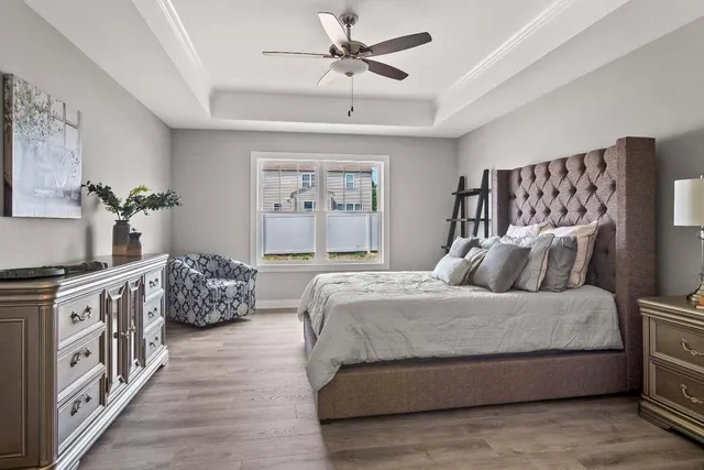 a bedroom with a large bed and a chandelier