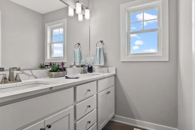 a bathroom with a sink a vanity and a mirror