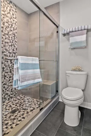 a bathroom with a toilet and a shower