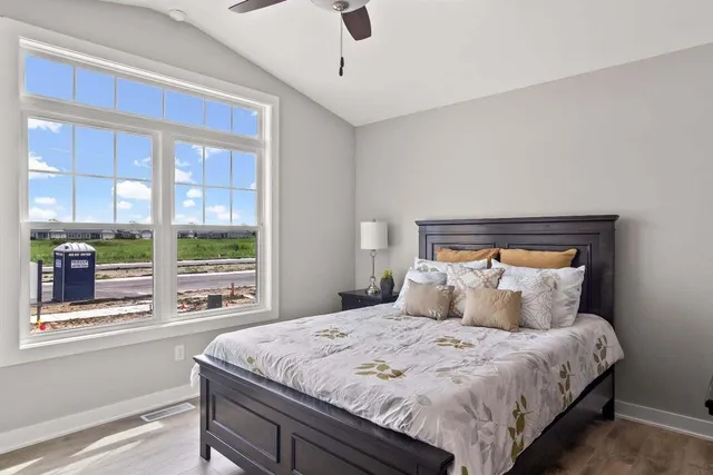 a bedroom with a large bed and a large window